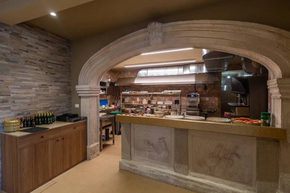 The open kitchen behind its stone arch
